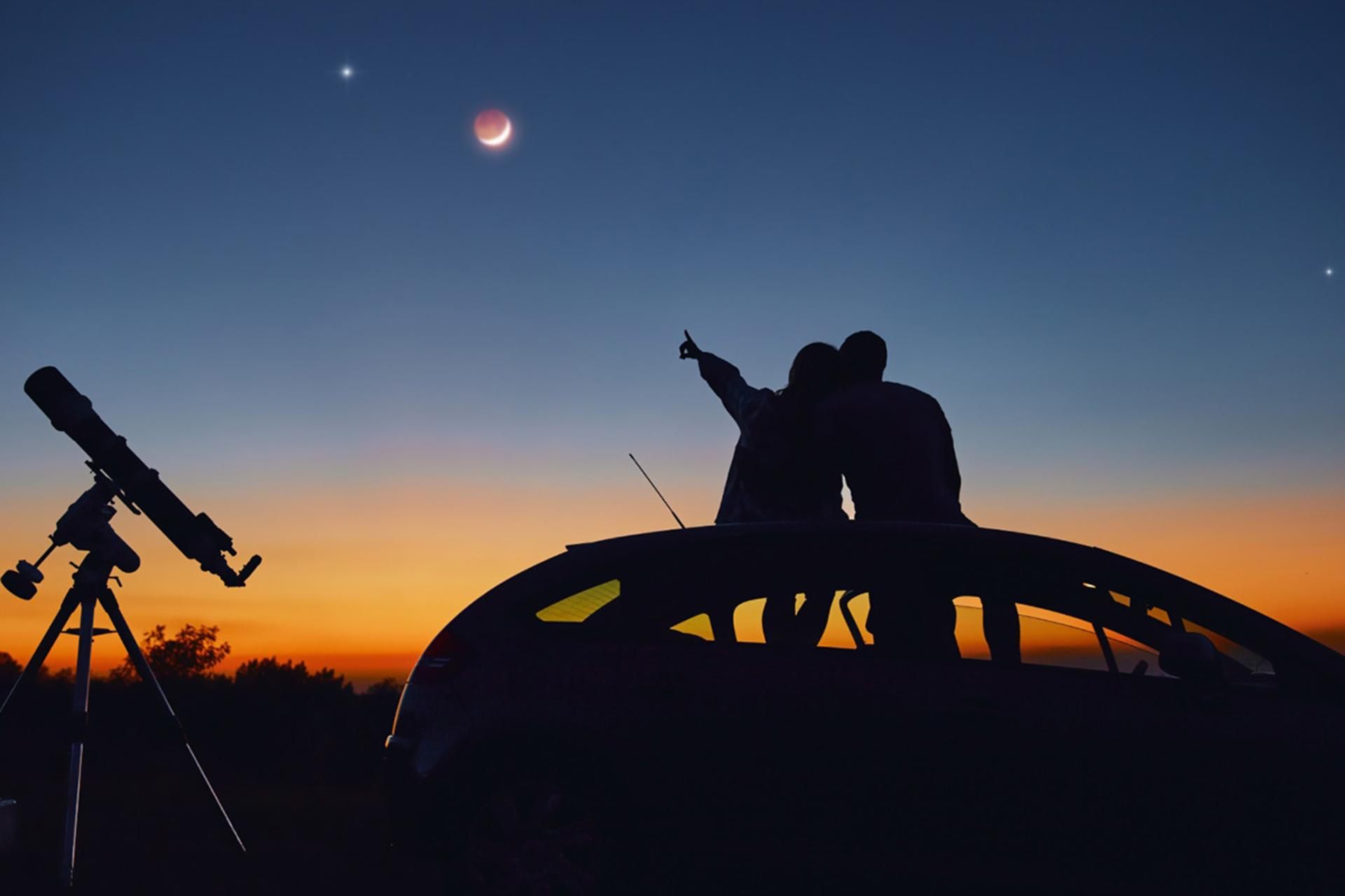 دو نفر در حال تماشای آسمان و ستاره‌ها برای انتخاب مقصد سفری بر اساس آستروکارتوگرافی